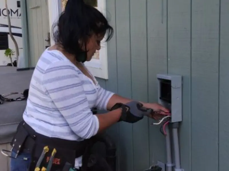 Licensed electrician wiring an exterior subpanel in Florence